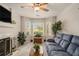 Cozy living room with a fireplace, bay windows, and plush seating at 3979 White Owl Nw Ct, Duluth, GA 30097