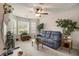 Comfortable living room featuring a plush sofa, bay windows, and a fireplace at 3979 White Owl Nw Ct, Duluth, GA 30097