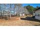 Expansive backyard with mature trees and a black-fenced area, with possible area for gardening or play at 6218 Old Stilesboro Nw Rd, Acworth, GA 30101