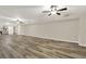 Finished basement area with plank flooring, ceiling fans and neutral paint palette at 6218 Old Stilesboro Nw Rd, Acworth, GA 30101