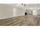 Finished basement area with plank flooring and a kitchenette with gray cabinetry at 6218 Old Stilesboro Nw Rd, Acworth, GA 30101