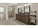 Elegant bathroom featuring double vanity, framed mirrors, decorative accents, and a tiled walk-in shower at 6218 Old Stilesboro Nw Rd, Acworth, GA 30101