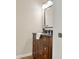 Half bathroom featuring hardwood floors, a wood vanity and a dark countertop at 6218 Old Stilesboro Nw Rd, Acworth, GA 30101