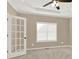 Bedroom featuring neutral walls, plush carpet, ceiling fan, and french doors at 6218 Old Stilesboro Nw Rd, Acworth, GA 30101