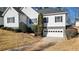 Charming home exterior with a two-car garage, complemented by lush landscaping and a well-maintained lawn at 6218 Old Stilesboro Nw Rd, Acworth, GA 30101