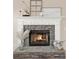 Close up of a stone fireplace with a white mantel and decorative accents, creating a cozy atmosphere at 6218 Old Stilesboro Nw Rd, Acworth, GA 30101