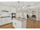 Bright kitchen features white cabinetry, granite countertops, a kitchen island and stainless steel appliances at 6218 Old Stilesboro Nw Rd, Acworth, GA 30101