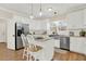 Bright kitchen showcasing white cabinetry, stainless steel appliances, and a center island with seating at 6218 Old Stilesboro Nw Rd, Acworth, GA 30101