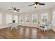 Cozy living room with ample natural light, hardwood floors, and comfortable seating at 6218 Old Stilesboro Nw Rd, Acworth, GA 30101