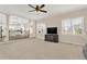 Spacious living room featuring plush carpeting, an entertainment center, and ample natural light at 6218 Old Stilesboro Nw Rd, Acworth, GA 30101