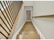 Well-lit staircase featuring wood steps, decorative metal railing, and natural light for a grand entrance at 6218 Old Stilesboro Nw Rd, Acworth, GA 30101
