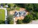 An aerial view showcases the home's setting amongst mature trees and a long driveway at 6428 East Cherokee Dr, Canton, GA 30115