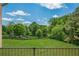 Beautiful backyard view from the porch, featuring a well-manicured lawn and mature trees at 6428 East Cherokee Dr, Canton, GA 30115