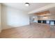 Spacious open basement with light wood floors and a bar area in the background at 6428 East Cherokee Dr, Canton, GA 30115