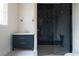 Modern bathroom features a large glass enclosed shower with dark tile and a vanity with marble countertop at 6428 East Cherokee Dr, Canton, GA 30115