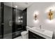 Modern bathroom with a glass enclosed shower, black tile, and a sleek white vanity at 6428 East Cherokee Dr, Canton, GA 30115