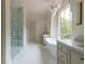 Bright bathroom with large window, soaking tub, glass shower, and dual vanities at 6428 East Cherokee Dr, Canton, GA 30115