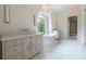 Bright bathroom with soaking tub, dual vanities, large window with view and herringbone floor at 6428 East Cherokee Dr, Canton, GA 30115