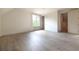 A bright bedroom features neutral walls and flooring, complemented by natural light from a single window at 6428 East Cherokee Dr, Canton, GA 30115