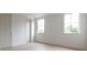 A bright bedroom features neutral walls and flooring, complemented by natural light from two windows at 6428 East Cherokee Dr, Canton, GA 30115