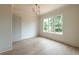 Bright, spacious bedroom featuring hardwood floors, a large window, and fresh, neutral paint at 6428 East Cherokee Dr, Canton, GA 30115