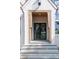 Stunning entryway featuring a custom black steel front door, natural wood accents, and gray stone steps at 6428 East Cherokee Dr, Canton, GA 30115
