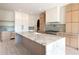 Kitchen with marble island, custom cabinetry, stainless steel appliances, and hood at 6428 East Cherokee Dr, Canton, GA 30115
