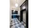 Modern kitchen boasts sleek black cabinetry, stainless steel appliances, and checkered marble floors at 6428 East Cherokee Dr, Canton, GA 30115