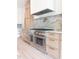 A gourmet kitchen features stainless steel appliances, modern cabinetry, and range hood at 6428 East Cherokee Dr, Canton, GA 30115
