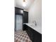 Laundry room features black cabinets, white countertops, decorative tile flooring, and ample storage at 6428 East Cherokee Dr, Canton, GA 30115