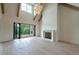 Open living room featuring wood floors, fireplace, wood beams, and expansive folding glass doors to the deck at 6428 East Cherokee Dr, Canton, GA 30115