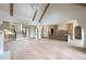 Bright, open-concept living room with vaulted ceilings, wood beams, chandelier, and hardwood floors at 6428 East Cherokee Dr, Canton, GA 30115