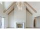 Bright living room with vaulted ceilings, wood beams, modern fireplace, and a stunning chandelier at 6428 East Cherokee Dr, Canton, GA 30115