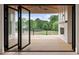 Spacious wood patio with views, folding glass doors, and an outdoor fireplace at 6428 East Cherokee Dr, Canton, GA 30115