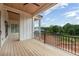 Spacious porch area with wooden floors and railings overlooking the backyard at 6428 East Cherokee Dr, Canton, GA 30115