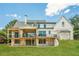 Spacious backyard with an expansive lawn, a two-story deck, and a modern white farmhouse exterior at 6428 East Cherokee Dr, Canton, GA 30115