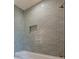 The tiled shower features a built-in shelf and a contemporary shower head at 6428 East Cherokee Dr, Canton, GA 30115