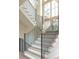 Close up of elegant staircase with light wood steps and black steel railings at 6428 East Cherokee Dr, Canton, GA 30115
