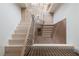 Bright modern staircase design features natural wood steps and black metal railings and decorative lighting at 6428 East Cherokee Dr, Canton, GA 30115