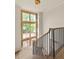 Beautiful staircase with wooden steps, black metal railing, and a large window letting in natural light at 6428 East Cherokee Dr, Canton, GA 30115