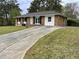 Quaint brick home featuring a long driveway and a well-maintained front yard at 6927 Eunice Dr, Riverdale, GA 30274