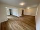 Spacious living room with hardwood floors, connecting to other rooms in the home at 6927 Eunice Dr, Riverdale, GA 30274