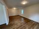 Bright, open-concept living room with hardwood floors, neutral walls, and natural light at 6927 Eunice Dr, Riverdale, GA 30274
