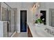Modern bathroom with double sinks, granite counters, and glass-enclosed shower at 7435 Jamestown Dr, Alpharetta, GA 30005