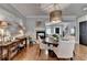 Elegant dining area with hardwood floors, stylish lighting, and a seamless transition to the living room and kitchen at 7435 Jamestown Dr, Alpharetta, GA 30005