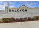 Modern brick Halcyon community entrance with landscaped shrubbery at 7435 Jamestown Dr, Alpharetta, GA 30005