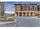Halcyon Grand mixed-use building featuring balconies and covered entry surrounded by well maintained landscaping and street access at 7435 Jamestown Dr, Alpharetta, GA 30005