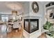 Stylish fireplace connecting dining and living areas, complemented by hardwood floors and a bright, open layout to the kitchen at 7435 Jamestown Dr, Alpharetta, GA 30005