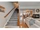 Welcoming foyer with hardwood floors, staircase, and view into the living room with fireplace at 7435 Jamestown Dr, Alpharetta, GA 30005