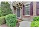 Inviting home entrance featuring a well-maintained brick facade, manicured greenery, and a welcoming front door with stylish accents at 7435 Jamestown Dr, Alpharetta, GA 30005